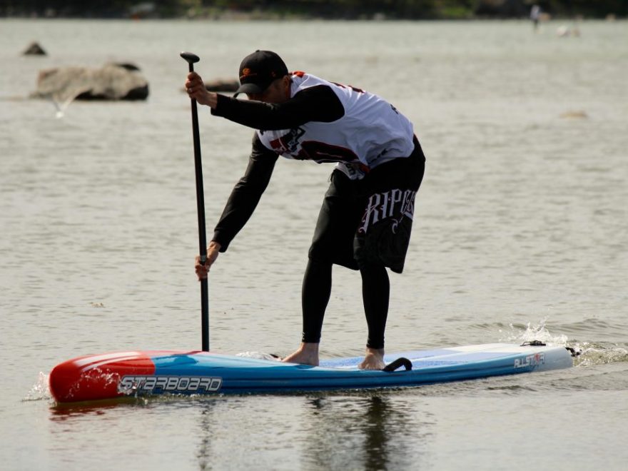 Stand Up Paddle boarder with choke stroke grip on paddle.