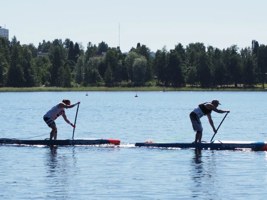 Paddle Board Racing. Starboard Race SUP boards on calm lake.